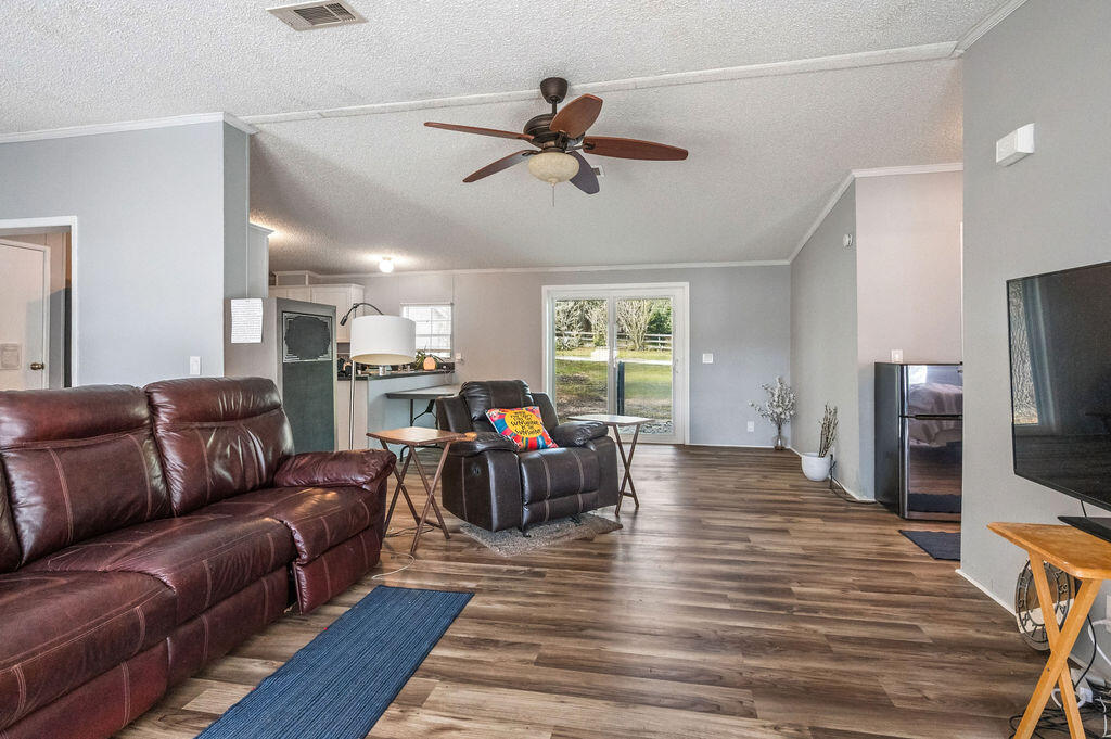 191 Beech Street Freeport, FL 32439 - Photo 2 of 18 a living room with furniture and a flat screen tv
