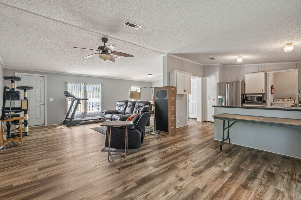 191 Beech Street Freeport, FL 32439 - Photo 3 of 18 a view of a workspace with furniture and a wooden floor