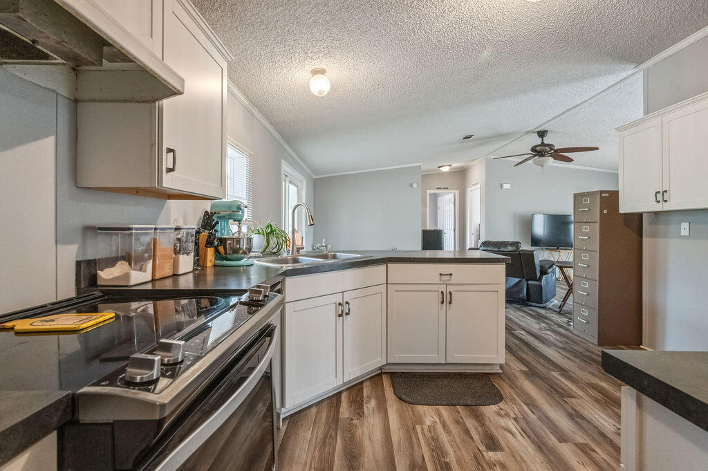 191 Beech Street Freeport, FL 32439 - Photo 8 of 18 a kitchen with a stove a sink and a refrigerator