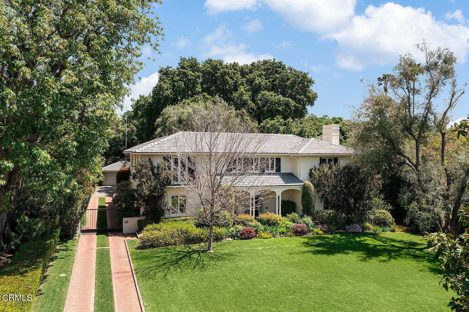 a view of a house with a yard and potted plants