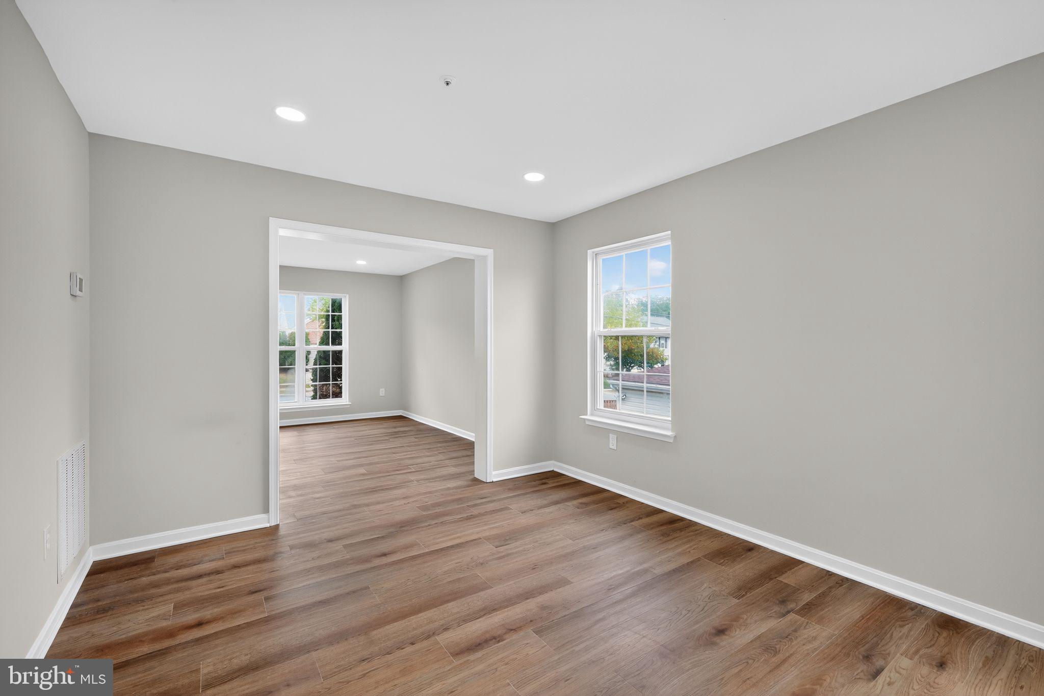 3003 Hillside Avenue Landover, MD 20785 - Photo 13 of 38 a view of an empty room with wooden floor and a window