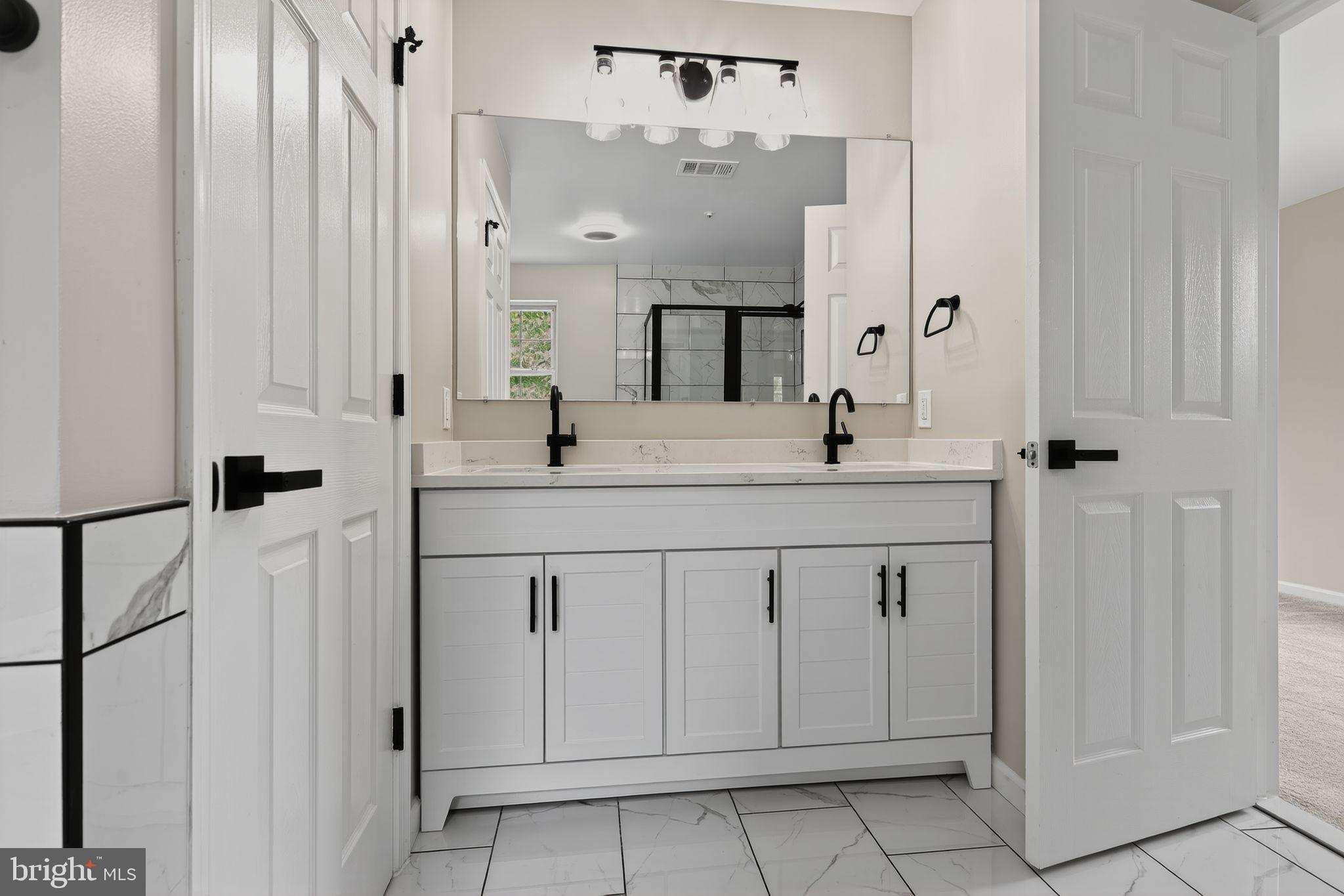 3003 Hillside Avenue Landover, MD 20785 - Photo 24 of 38 a bathroom with a double vanity sink and mirror