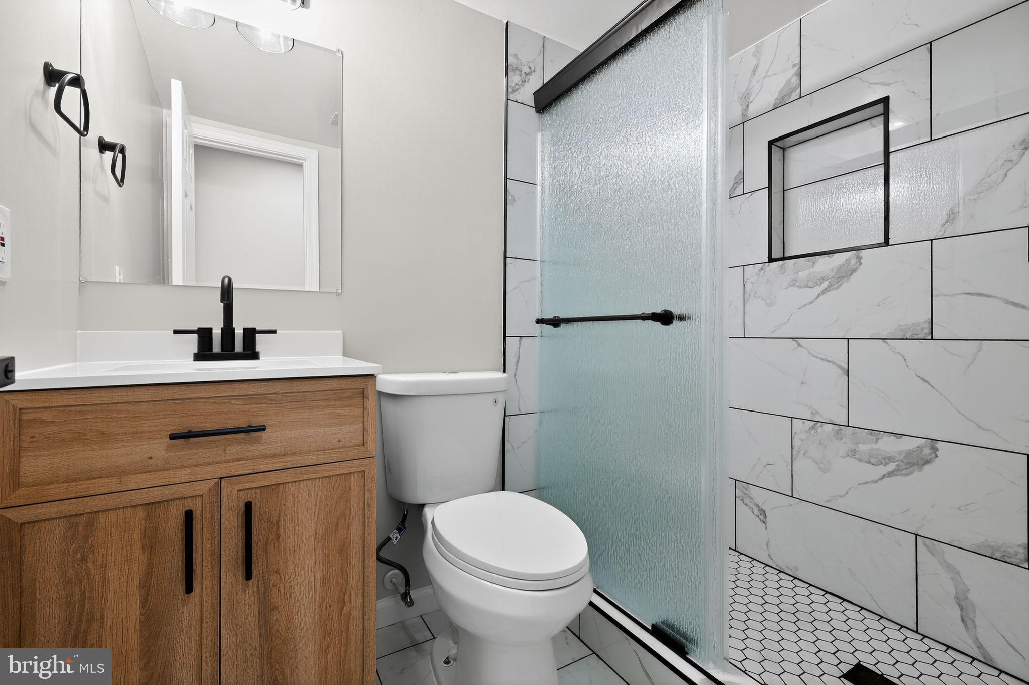 3003 Hillside Avenue Landover, MD 20785 - Photo 30 of 38 a bathroom with a sink toilet and shower