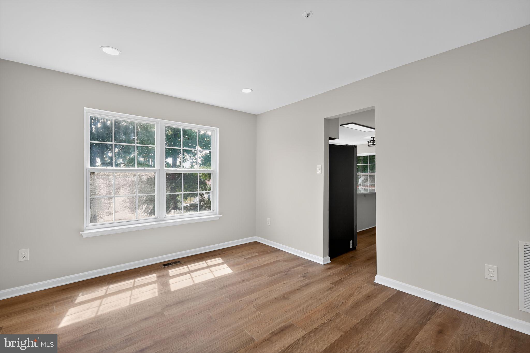 3003 Hillside Avenue Landover, MD 20785 - Photo 9 of 38 an empty room with wooden floor and windows