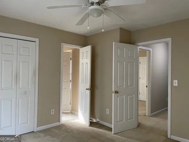 a view of a hallway with a chandelier fan