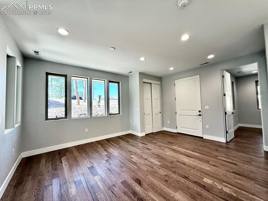 3155 Promise Point Colorado Springs, CO 80921 - Photo 7 of 26 an empty room with wooden floor and windows
