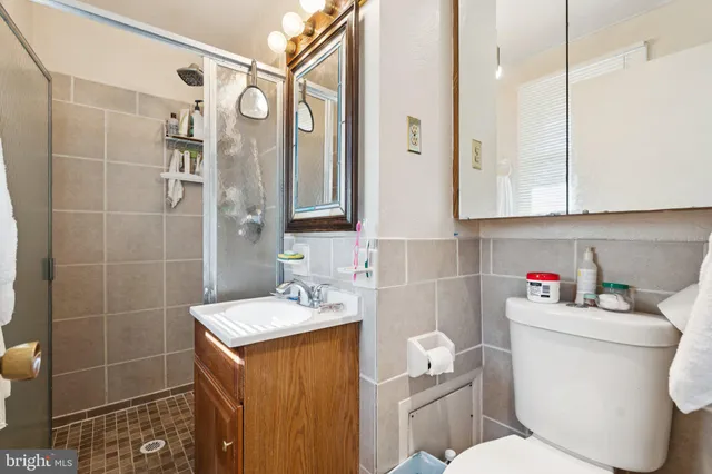 a bathroom with a sink a toilet and shower curtain
