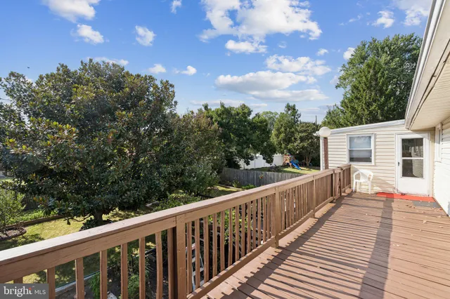 a balcony with wooden floor and fence