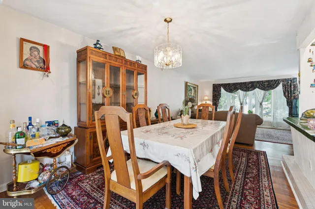 a view of a dining room with furniture and chandelier