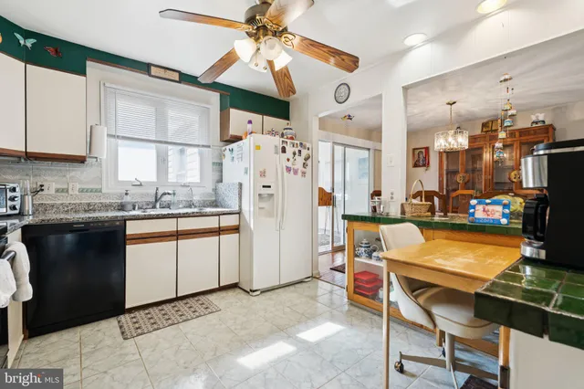 a kitchen with refrigerator and cabinets