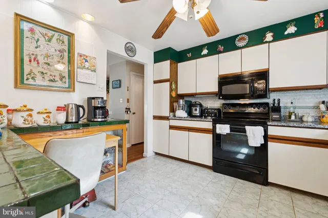 a kitchen with stainless steel appliances granite countertop a sink and a stove