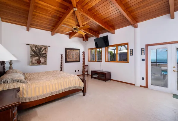 a bedroom with furniture and a flat screen tv