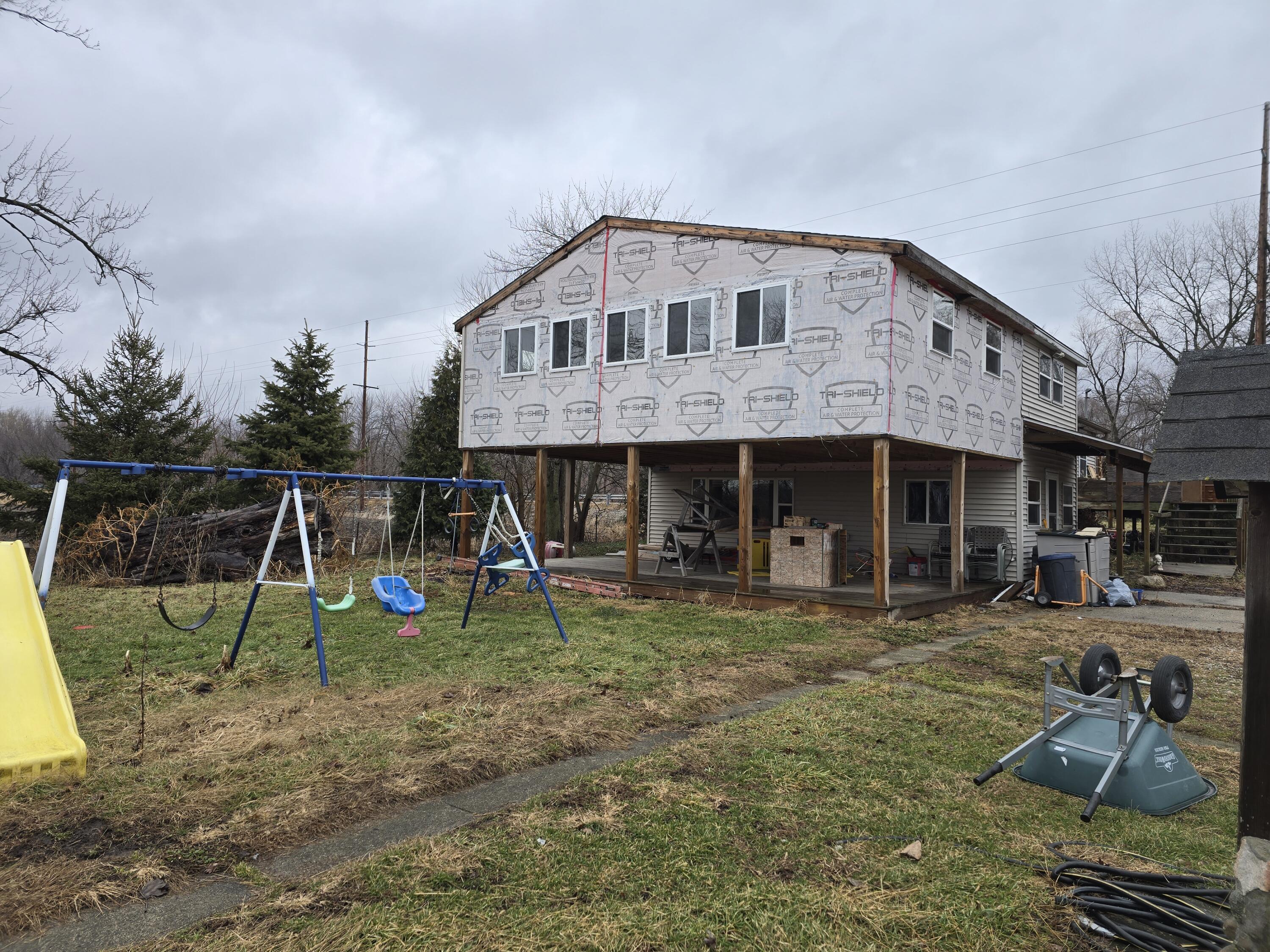 a view of a house with a yard and sitting area