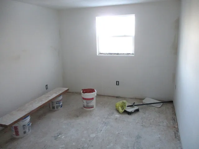 a room with a chair and a window