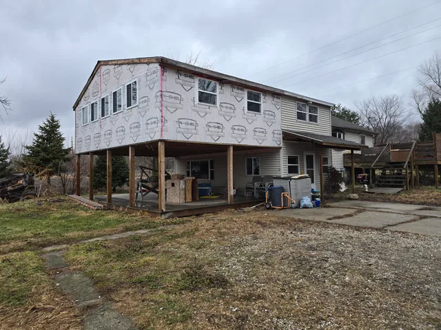 a front view of a house with sitting area and porch