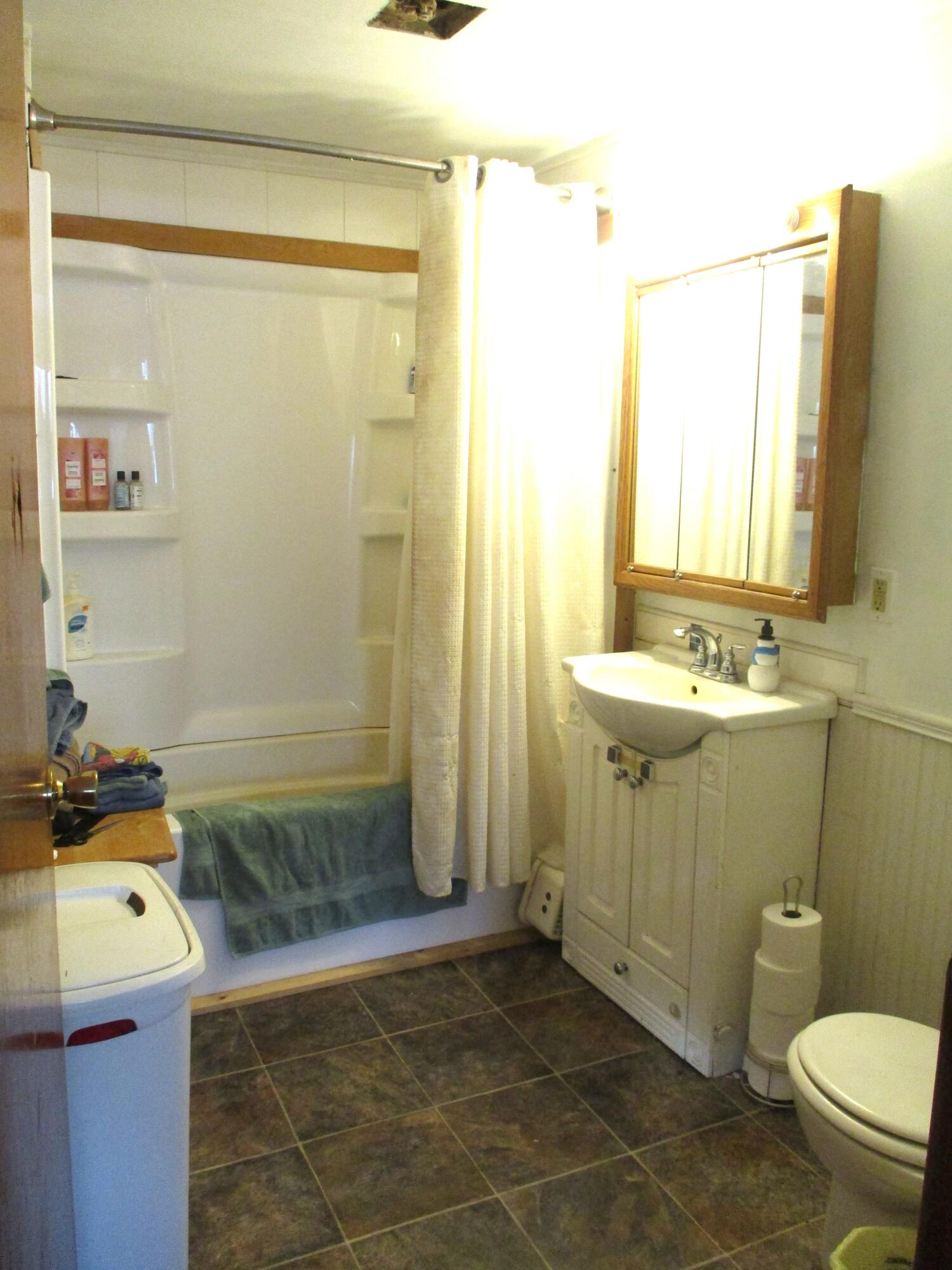 1158 South State Road Hebron, IN 46341 - Photo 6 of 19 a bathroom with a sink a toilet and shower
