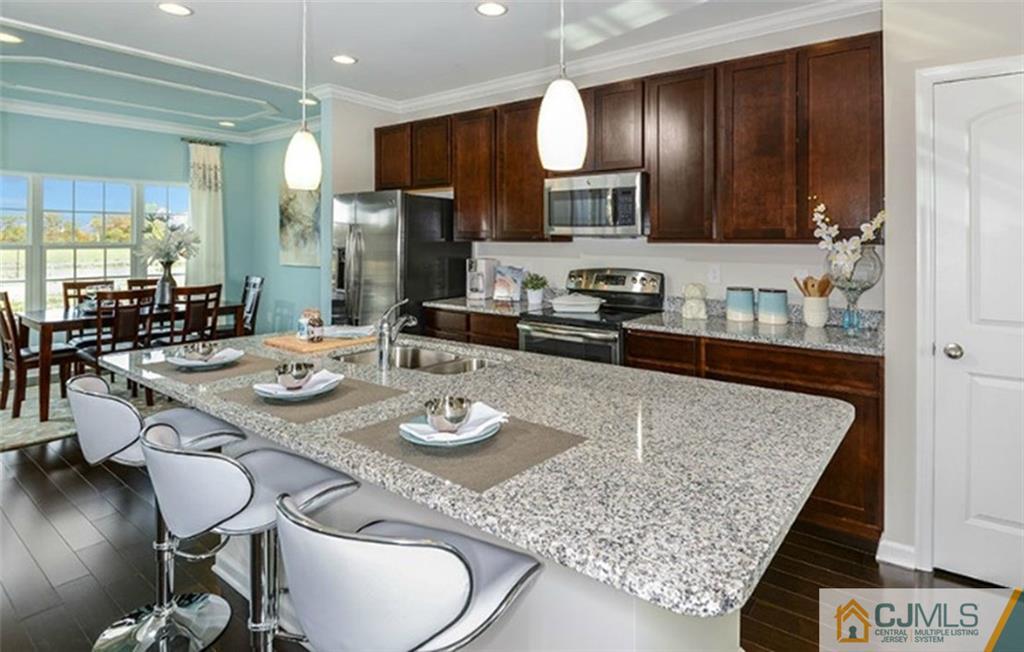 31 Iron Gate Road Sicklerville, NJ 08081 - Photo 1 of 4 a kitchen with sink granite counter and chairs