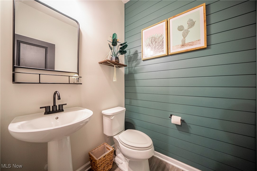 270 Stone Ridge Way Berea, OH 44017 - Photo 15 of 30 Bathroom featuring toilet, hardwood / wood-style flooring, and wood walls
