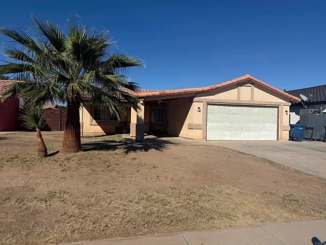 a view of a house with a yard and garage