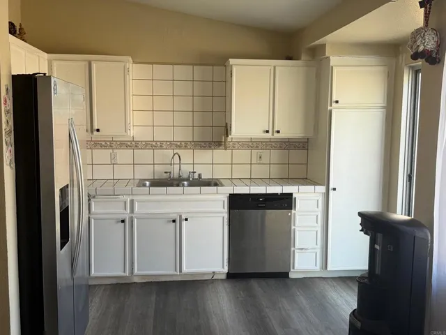 a kitchen with cabinets and steel stainless steel appliances