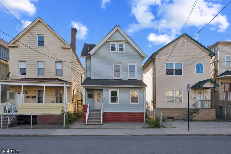 136 Smith Street Elizabeth, NJ 07201 - Photo 1 of 38 a front view of a house with a yard
