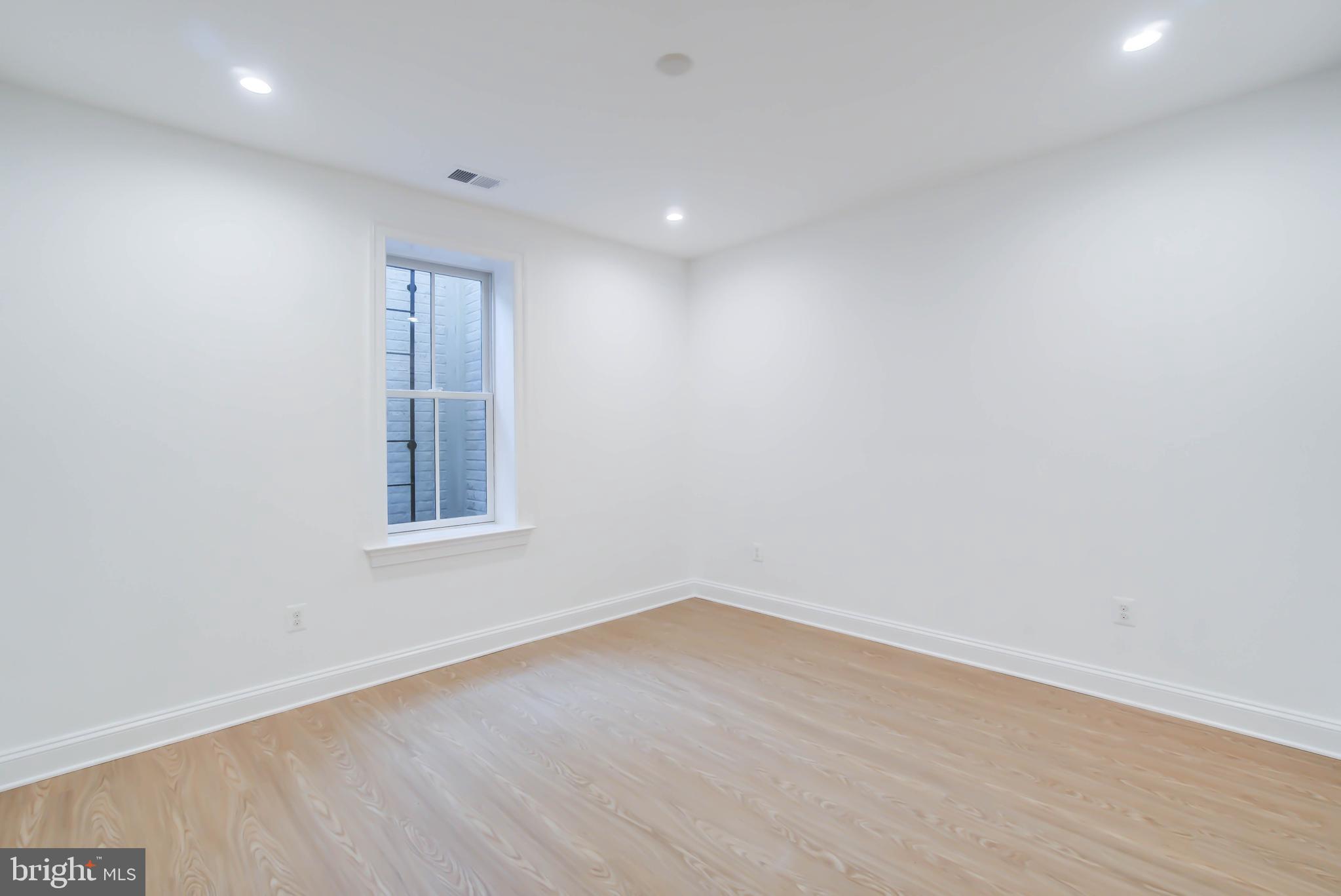 7408 Pyle Road Bethesda, MD 20817 - Photo 72 of 81 an empty room with wooden floor and windows