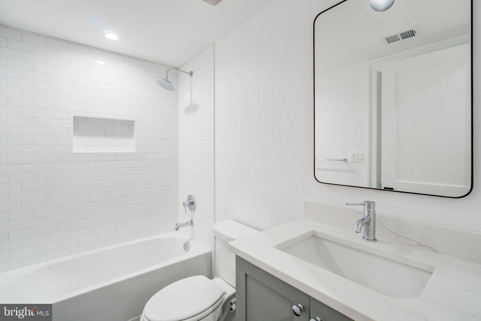 7408 Pyle Road Bethesda, MD 20817 - Photo 73 of 81 a bathroom with a bathtub shower sink vanity and toilet