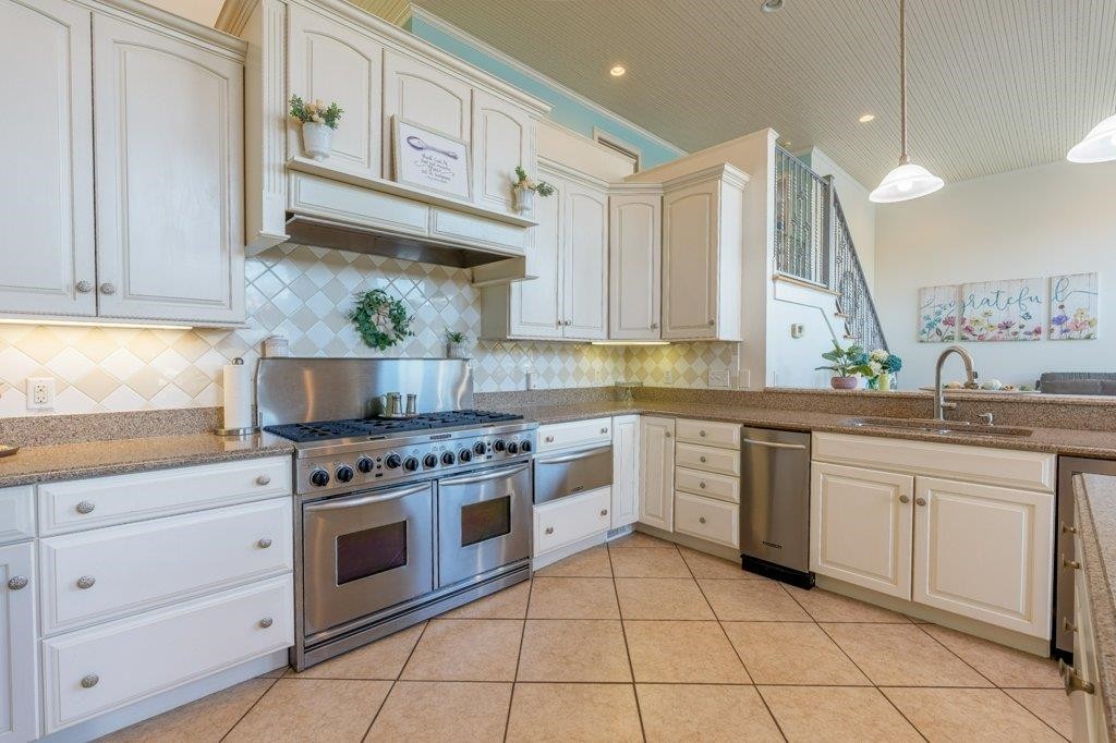 331 Carson Road Muscle Shoals, AL 35661 - Photo 20 of 38 a kitchen with stainless steel appliances granite countertop a stove sink and cabinets