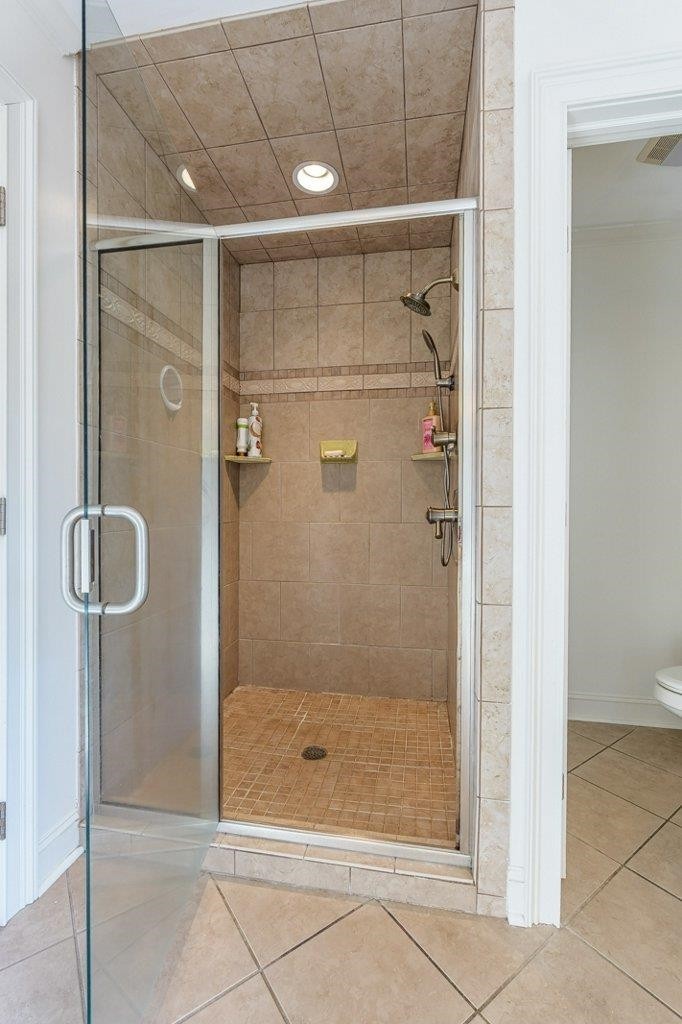 331 Carson Road Muscle Shoals, AL 35661 - Photo 27 of 38 a bathroom with a glass shower door