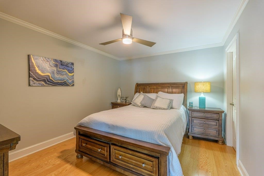 331 Carson Road Muscle Shoals, AL 35661 - Photo 29 of 38 a bedroom with a bed and a lamp on the dresser