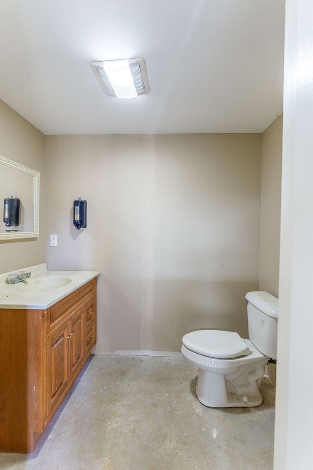 331 Carson Road Muscle Shoals, AL 35661 - Photo 35 of 38 a bathroom with a granite countertop toilet and a sink