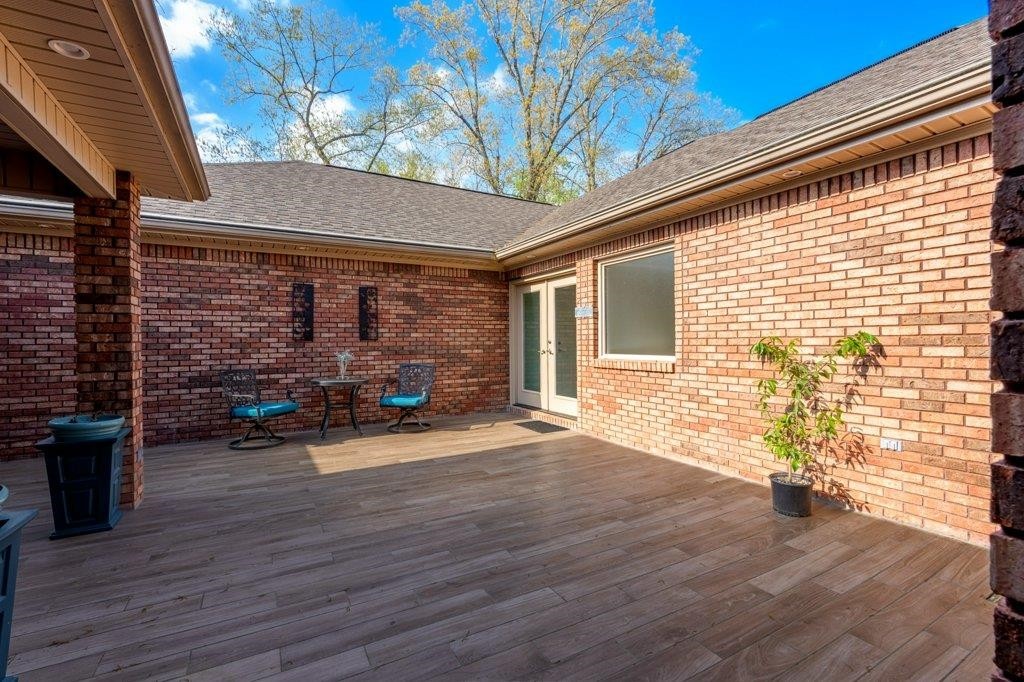 331 Carson Road Muscle Shoals, AL 35661 - Photo 6 of 38 a view of a patio with table and chairs and wooden floor