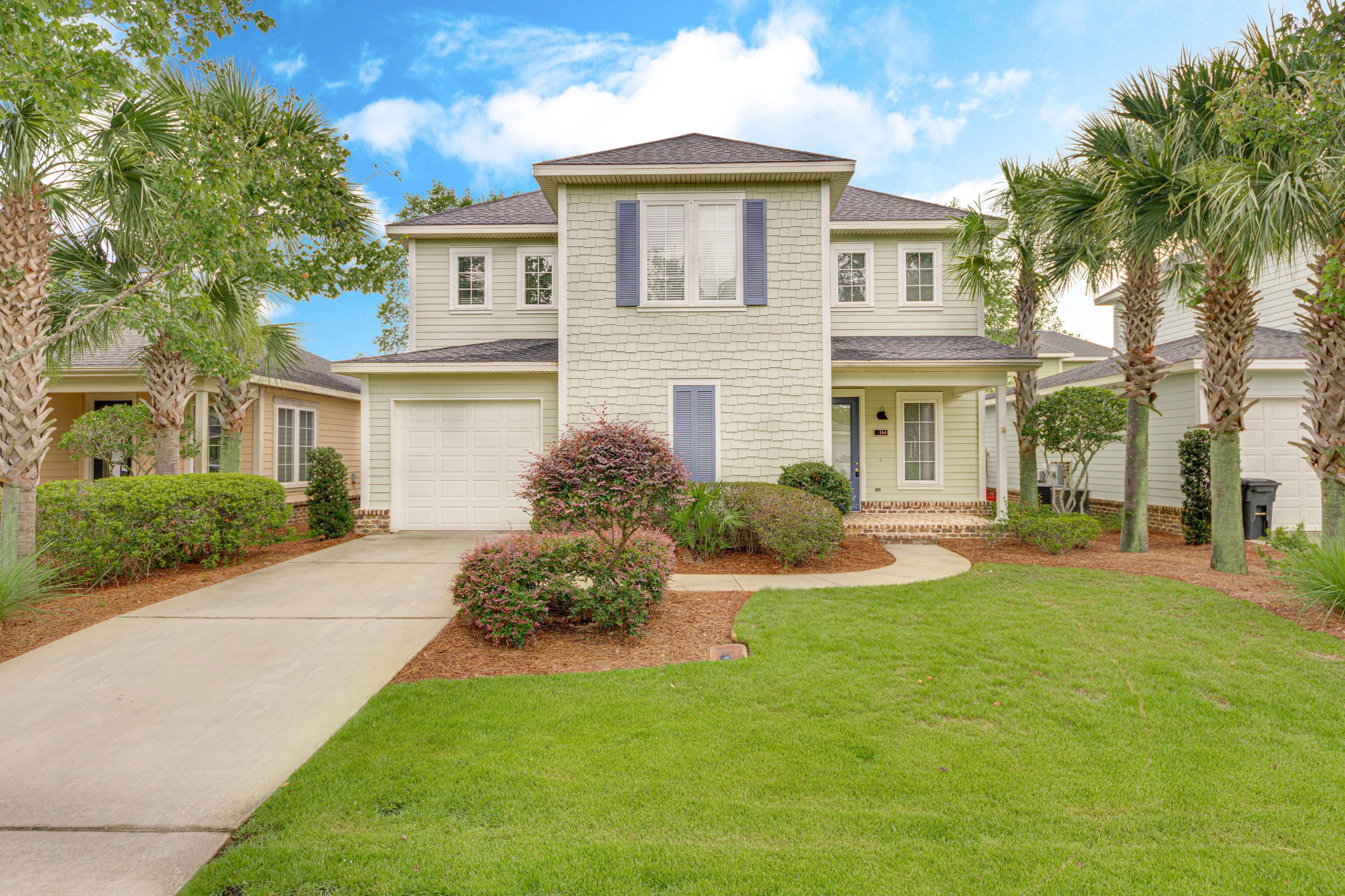 164 South Zander Way Santa Rosa Beach, FL 32459 - Photo 1 of 51 a front view of a house with a yard and palm trees