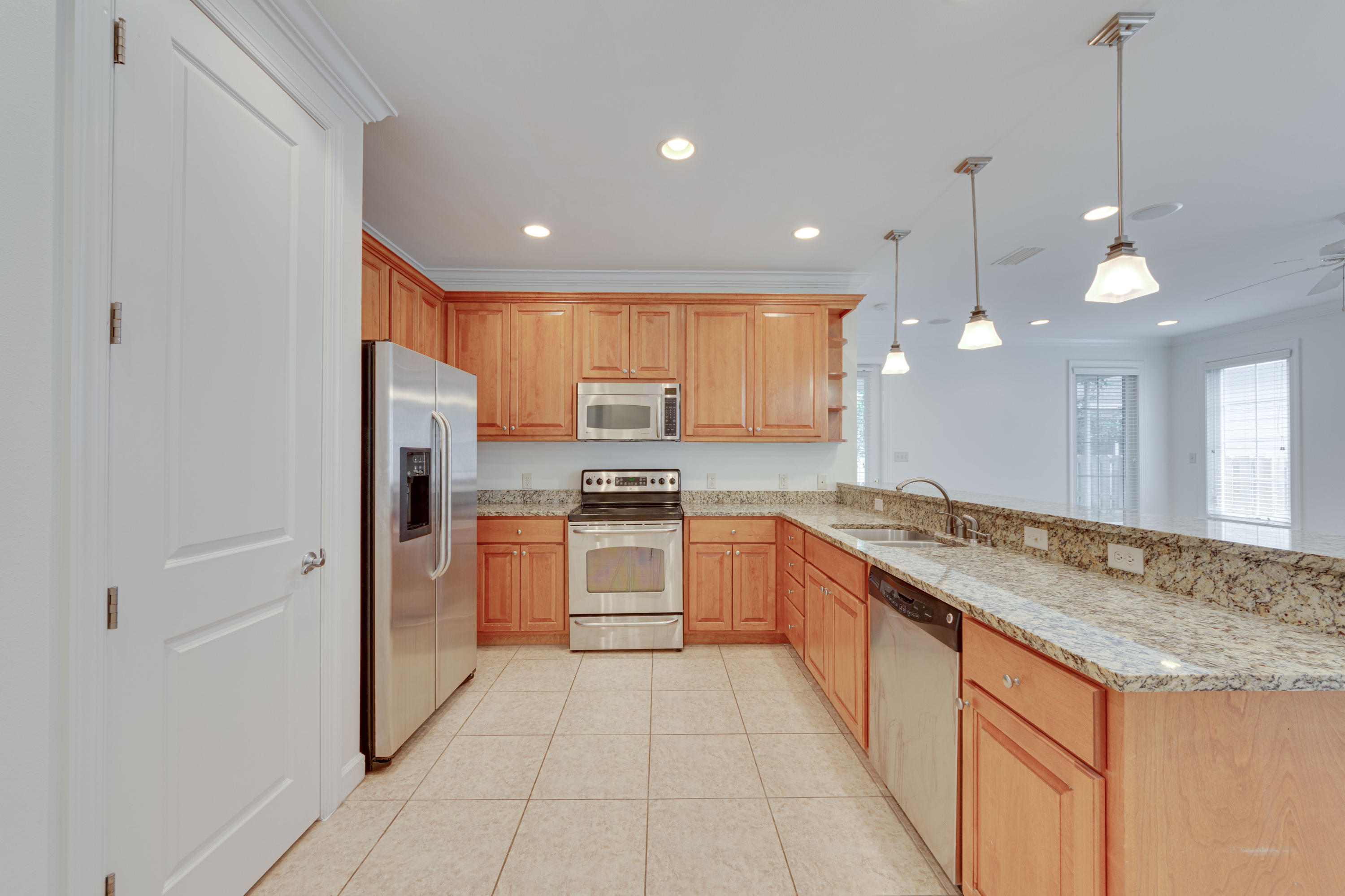 164 South Zander Way Santa Rosa Beach, FL 32459 - Photo 12 of 51 a large kitchen with granite countertop a large stove top oven a sink a counter space and stainless steel appliances