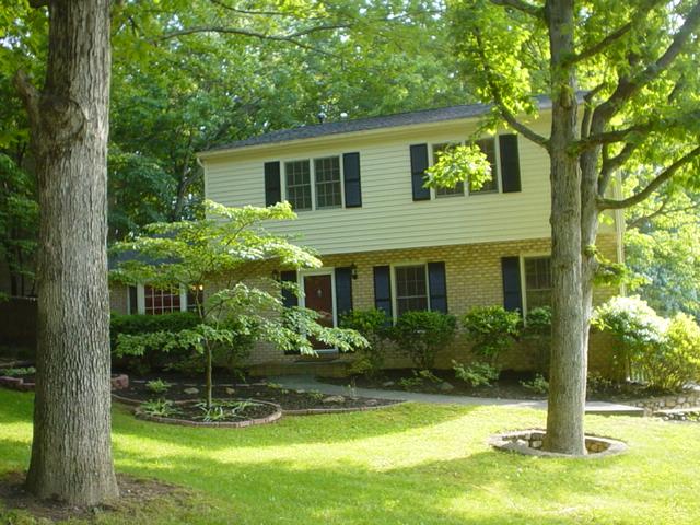 a view of a house with pool and garden