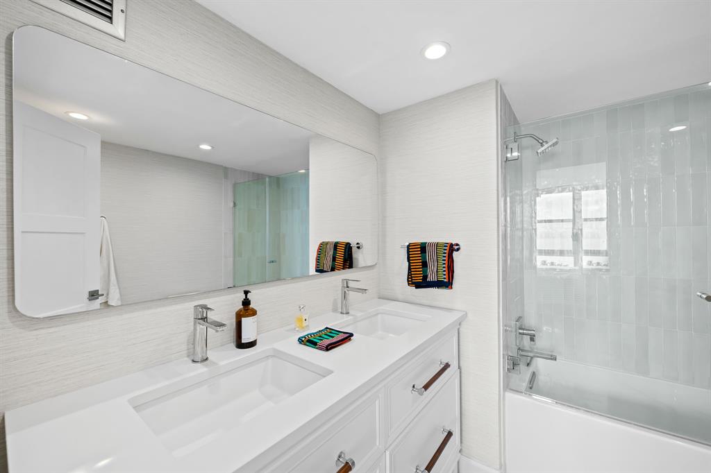 2841 North Ocean Boulevard, Unit 1508 Fort Lauderdale, FL 33308 - Photo 13 of 31 a bathroom with a tub sink and mirror