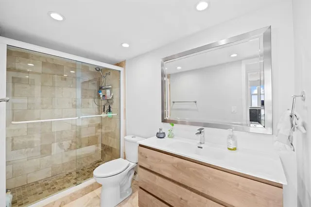 a bedroom with a large bed and a flat screen tv