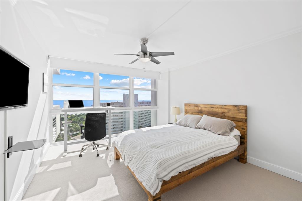 2841 North Ocean Boulevard, Unit 1508 Fort Lauderdale, FL 33308 - Photo 16 of 31 a bedroom with a large bed and a flat screen tv