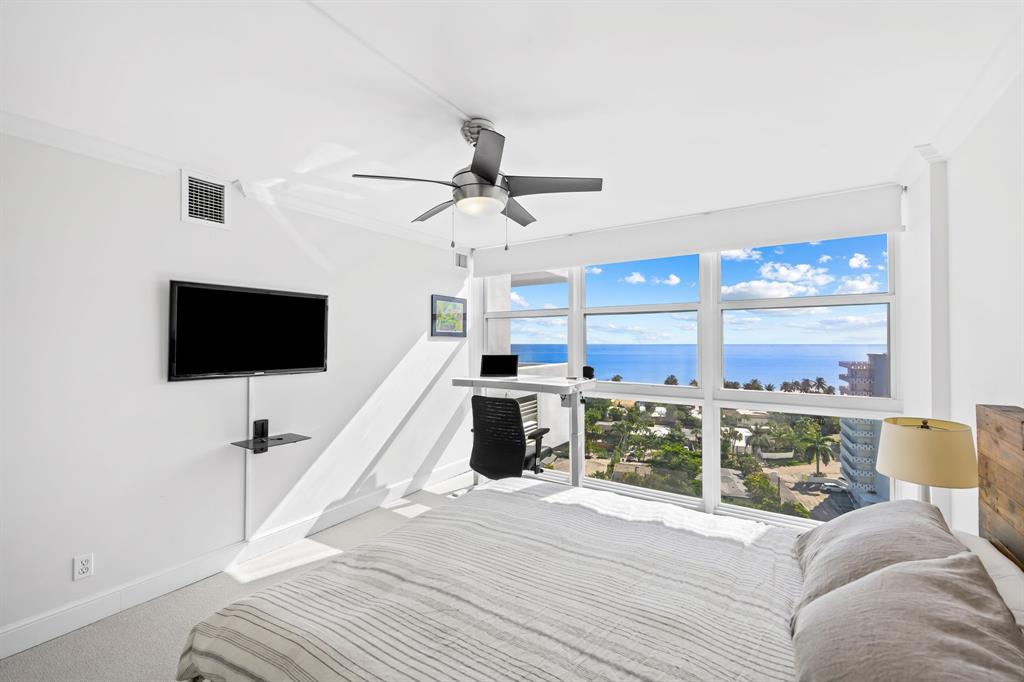 2841 North Ocean Boulevard, Unit 1508 Fort Lauderdale, FL 33308 - Photo 17 of 31 a living room with furniture a flat screen tv and a large window