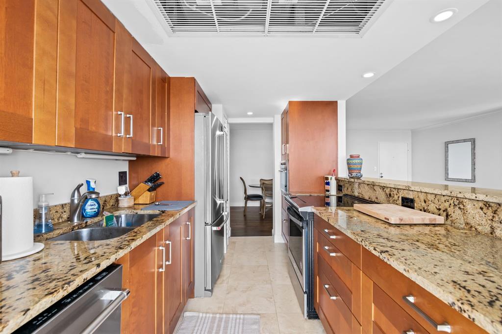 2841 North Ocean Boulevard, Unit 1508 Fort Lauderdale, FL 33308 - Photo 8 of 31 a kitchen with stainless steel appliances granite countertop a sink stove and refrigerator