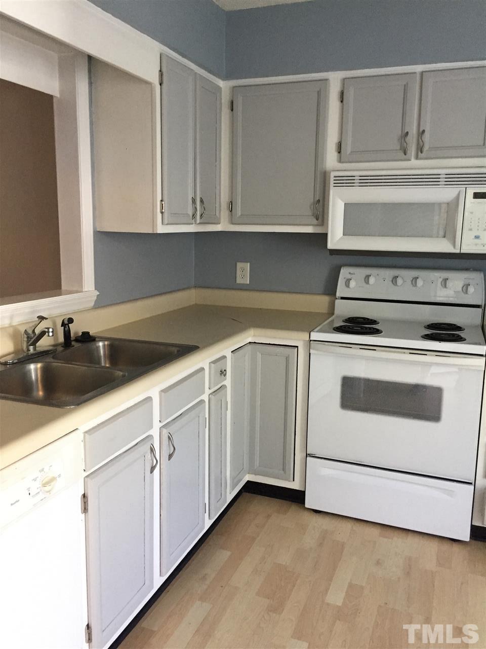 2043 Trexler Court Raleigh, NC 27606 - Photo 2 of 3 a kitchen with white cabinets and white appliances