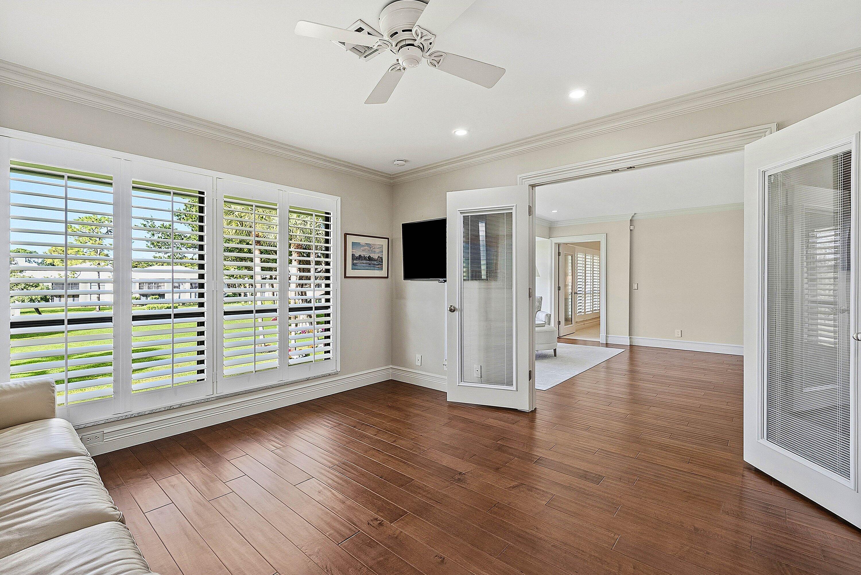 3675 Quail Ridge Drive, Unit BOBWHITE B Boynton Beach, FL 33436 - Photo 12 of 48 a view of an empty room with wooden floor and a window