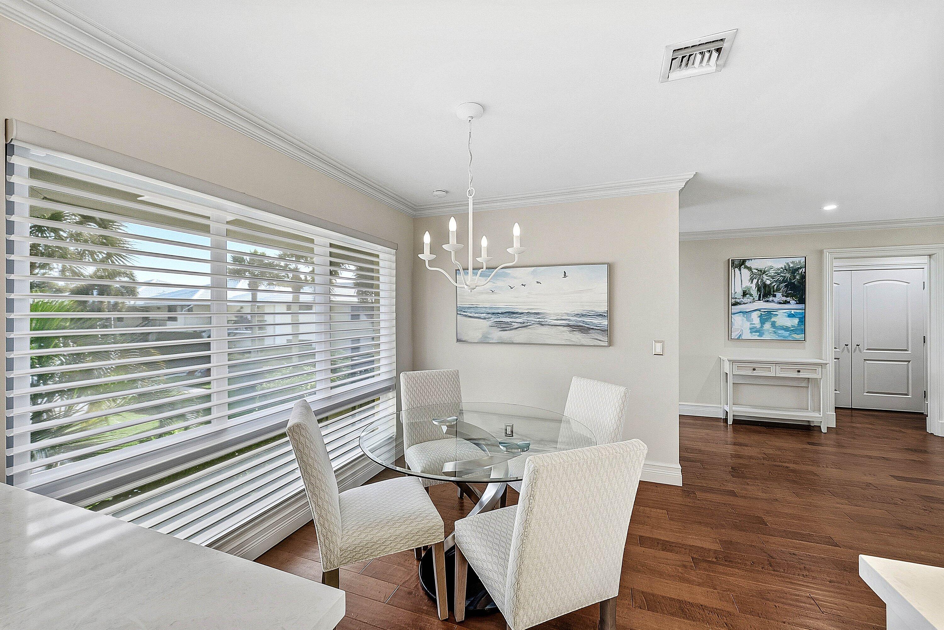 3675 Quail Ridge Drive, Unit BOBWHITE B Boynton Beach, FL 33436 - Photo 17 of 48 a view of a dining room with furniture window and wooden floor