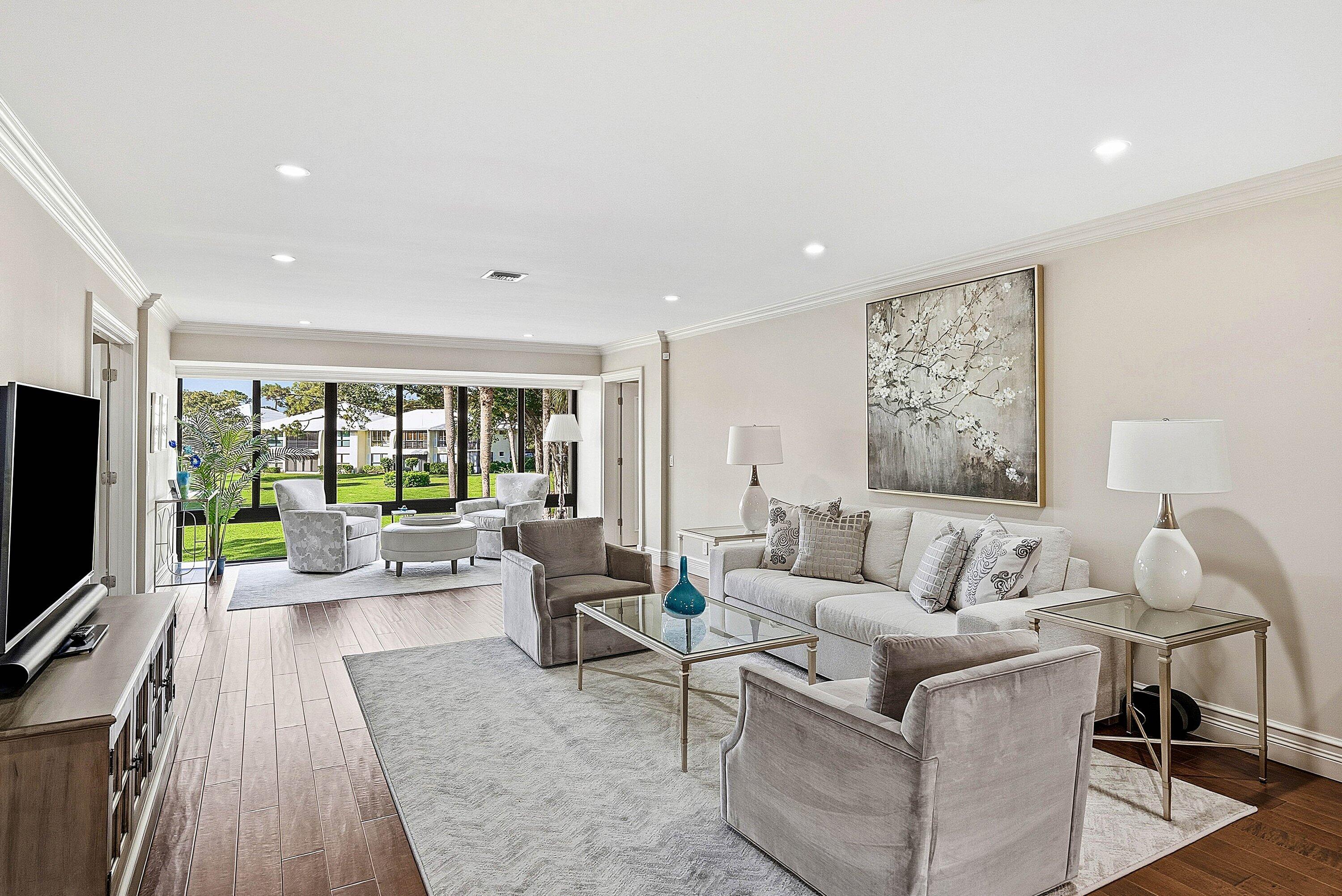 3675 Quail Ridge Drive, Unit BOBWHITE B Boynton Beach, FL 33436 - Photo 2 of 48 a living room with furniture and a flat screen tv