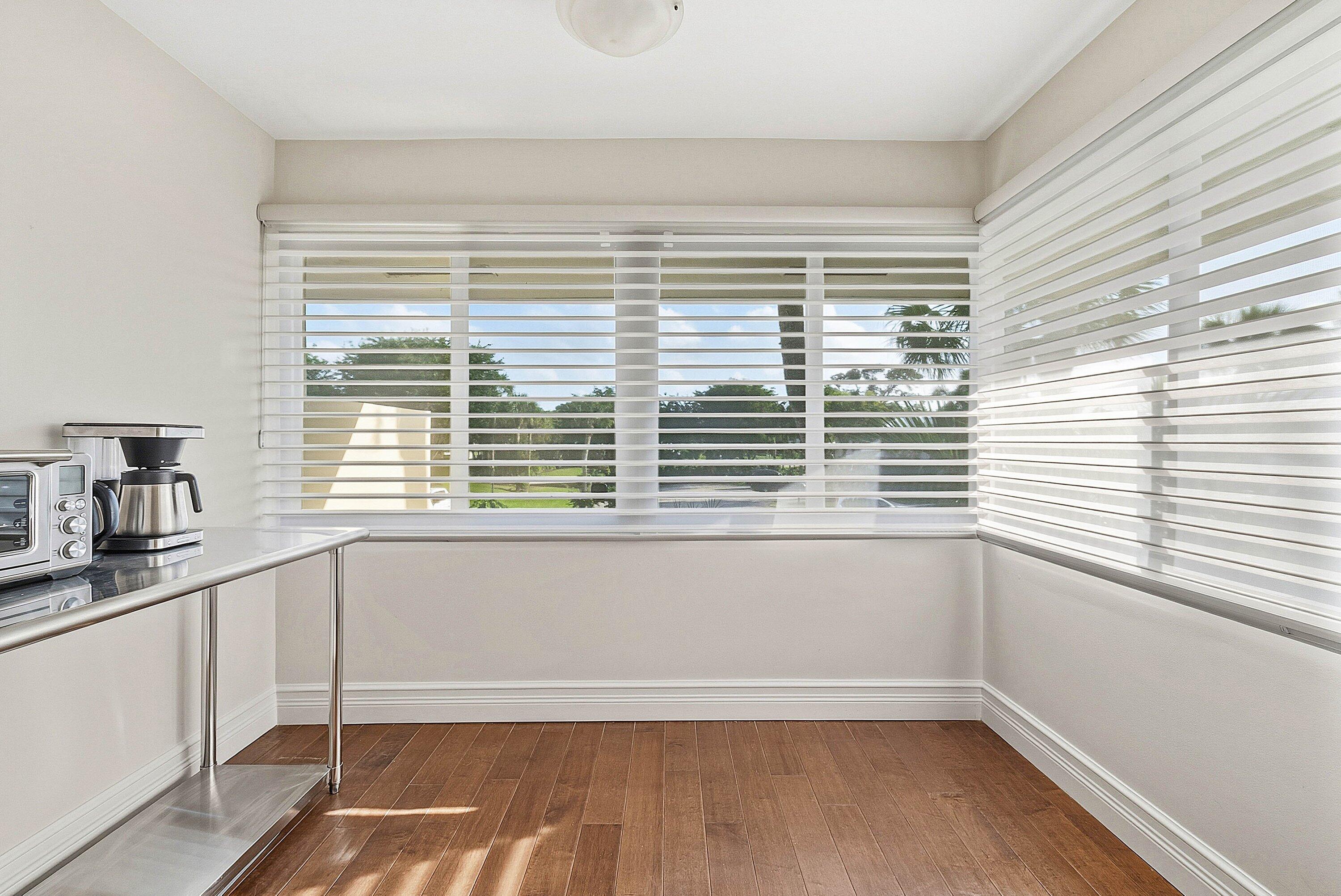 3675 Quail Ridge Drive, Unit BOBWHITE B Boynton Beach, FL 33436 - Photo 21 of 48 a view of a kitchen and microwave