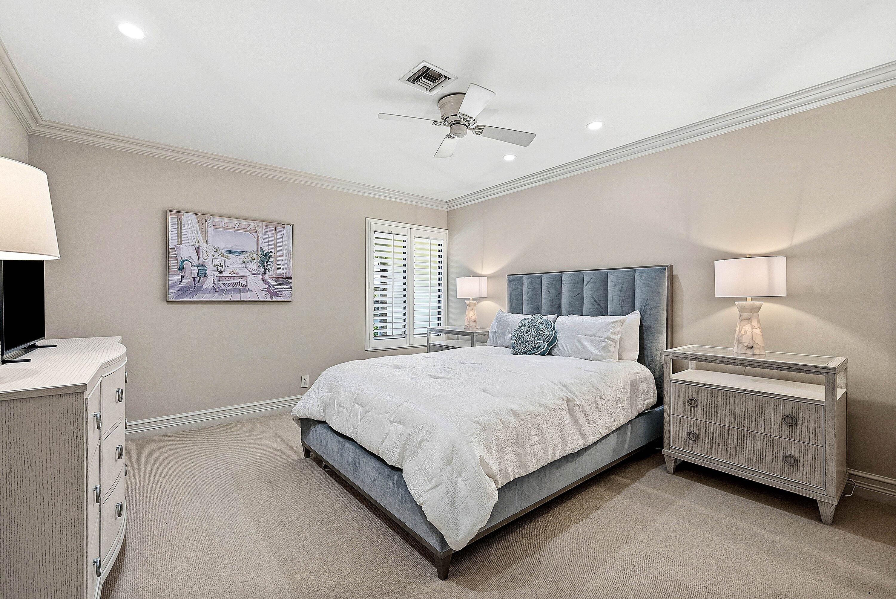 3675 Quail Ridge Drive, Unit BOBWHITE B Boynton Beach, FL 33436 - Photo 22 of 48 a bedroom with a large bed and a chandelier