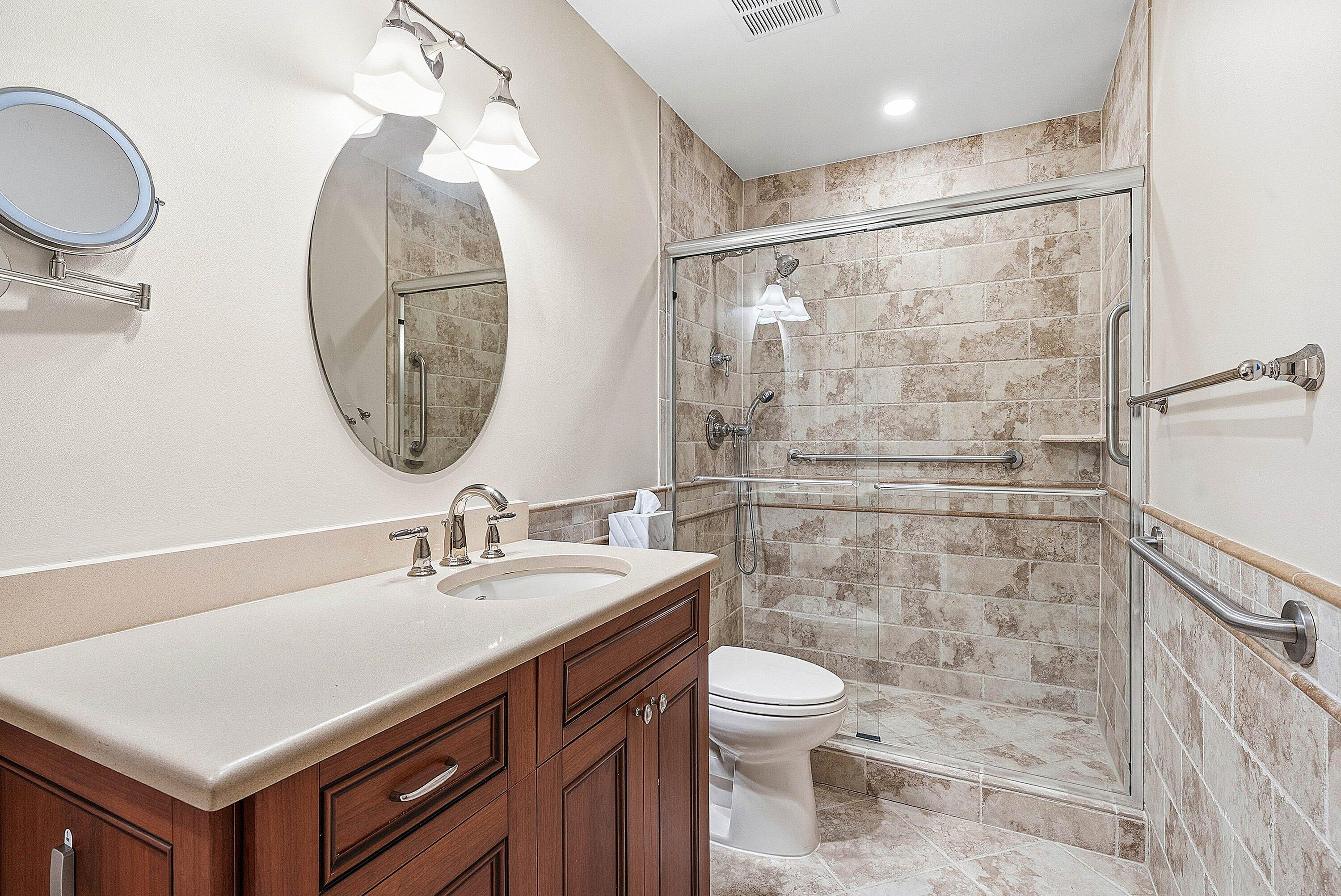 3675 Quail Ridge Drive, Unit BOBWHITE B Boynton Beach, FL 33436 - Photo 23 of 48 a bathroom with a sink mirror vanity and toilet
