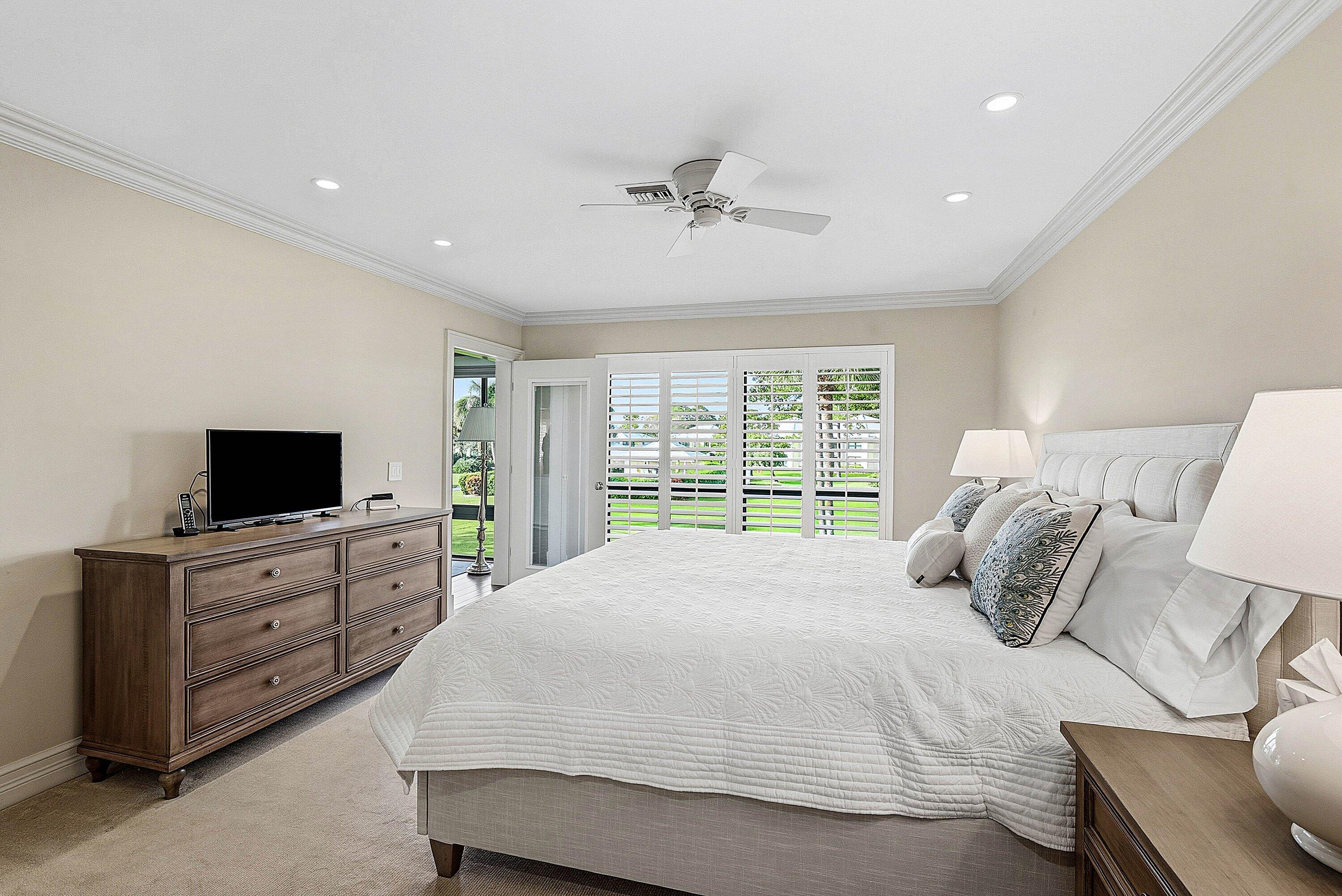 3675 Quail Ridge Drive, Unit BOBWHITE B Boynton Beach, FL 33436 - Photo 24 of 48 a bedroom with a bed and flat screen tv