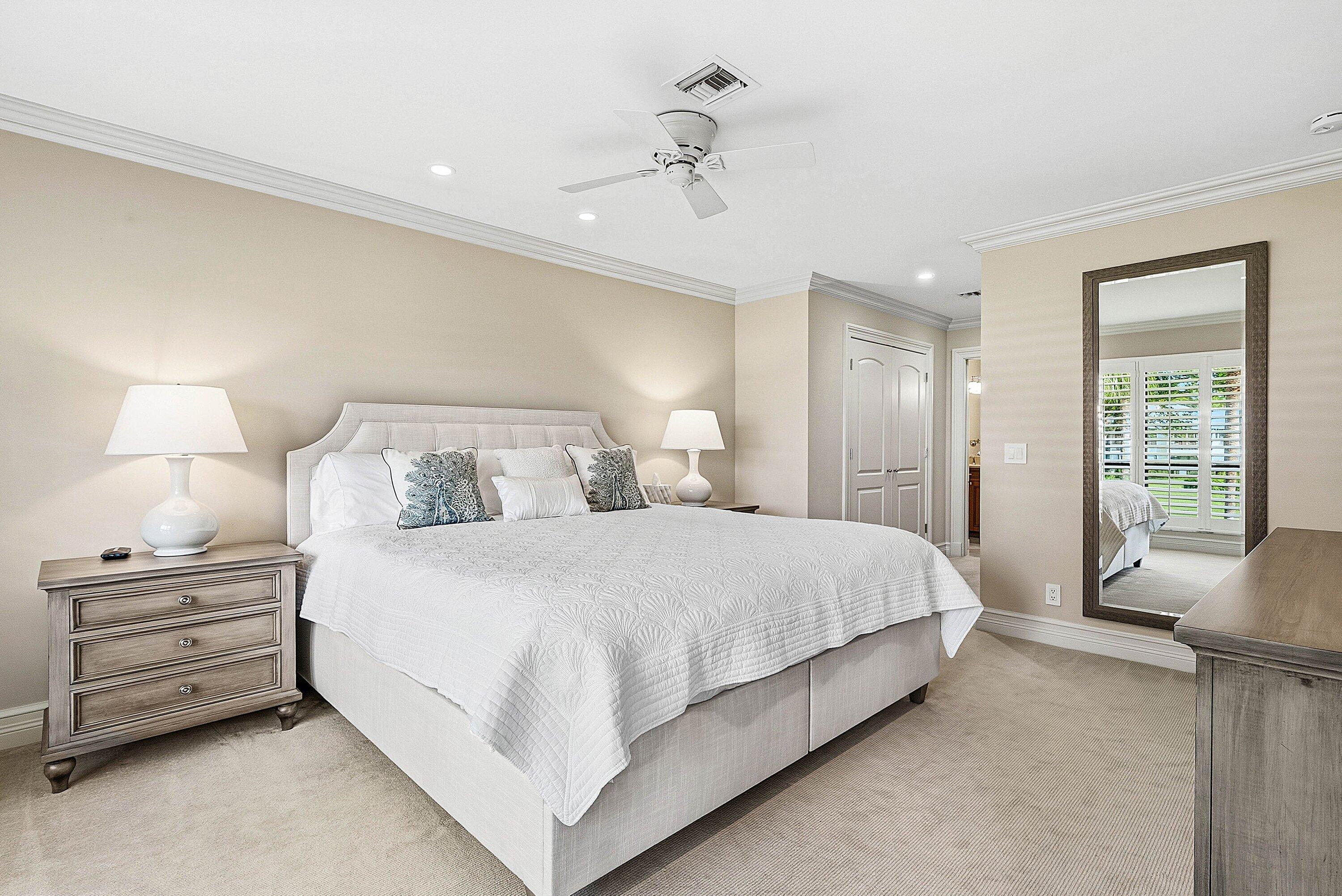 3675 Quail Ridge Drive, Unit BOBWHITE B Boynton Beach, FL 33436 - Photo 25 of 48 a bedroom with a bed and a chandelier