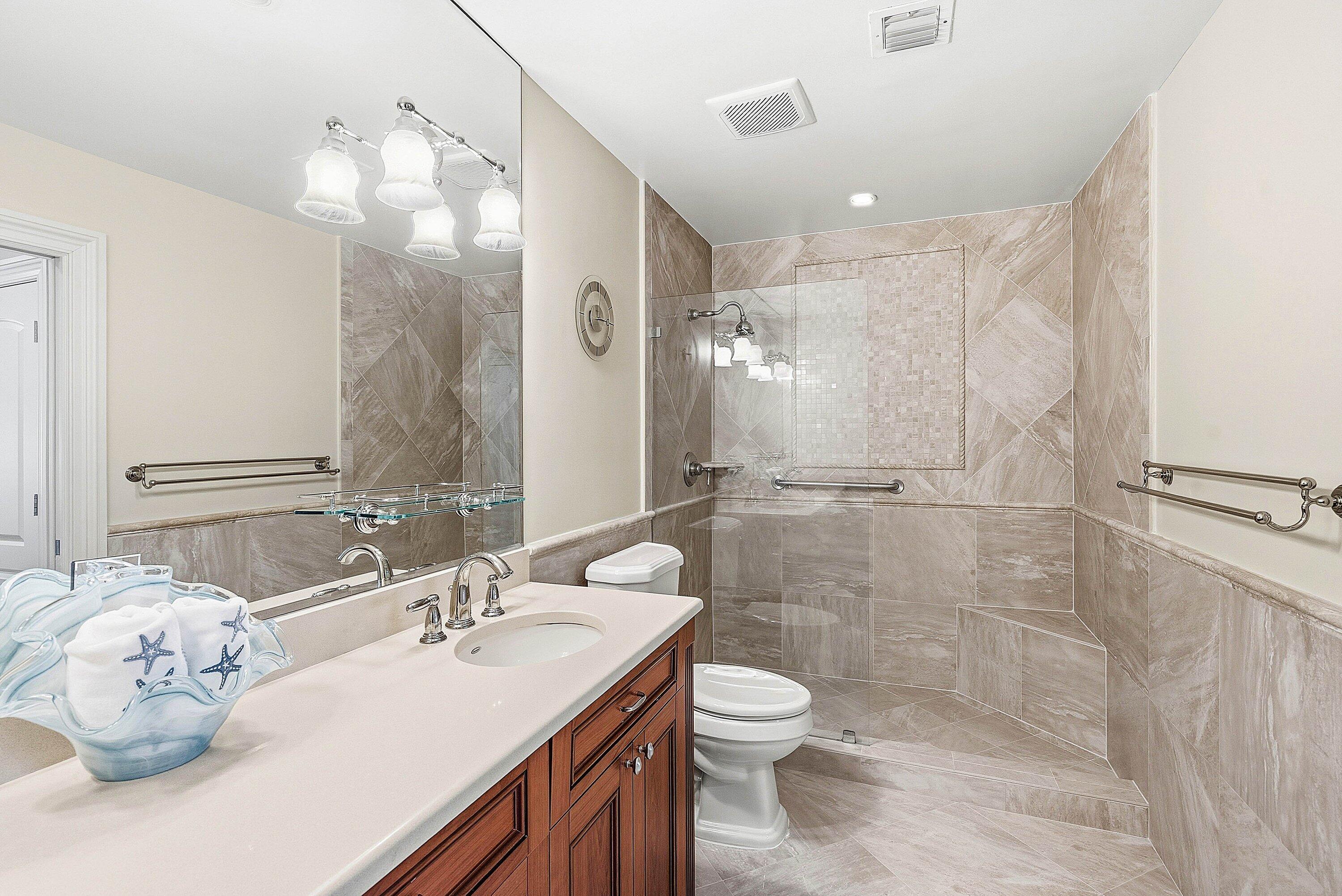3675 Quail Ridge Drive, Unit BOBWHITE B Boynton Beach, FL 33436 - Photo 27 of 48 a bathroom with a sink toilet and shower